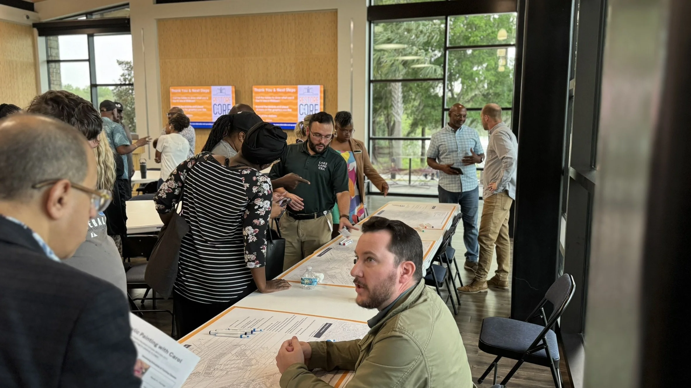 people seated at the public meeting sketch station