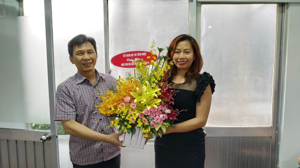 Nhà báo Văn Thị Bích Ty, phụ trách chuyên trang Thế giới Vi tính, trực thuộc Tạp chí Khám phá nhận lẵng hoa chúc mừng từ ông Nguyễn Việt Dũng, Giám đốc Sở Khoa học và Công nghệ TP.HCM. Ảnh: Tùng Lâm.