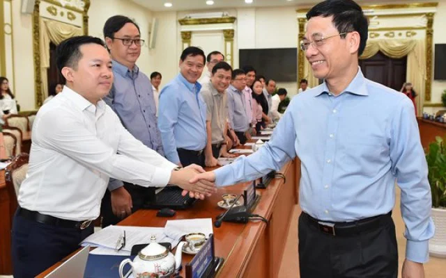 Bộ trưởng Bộ TT-TT Nguyễn Mạnh Hùng trao đổi cùng đại biểu dự hội nghị. Ảnh: VIỆT DŨNG