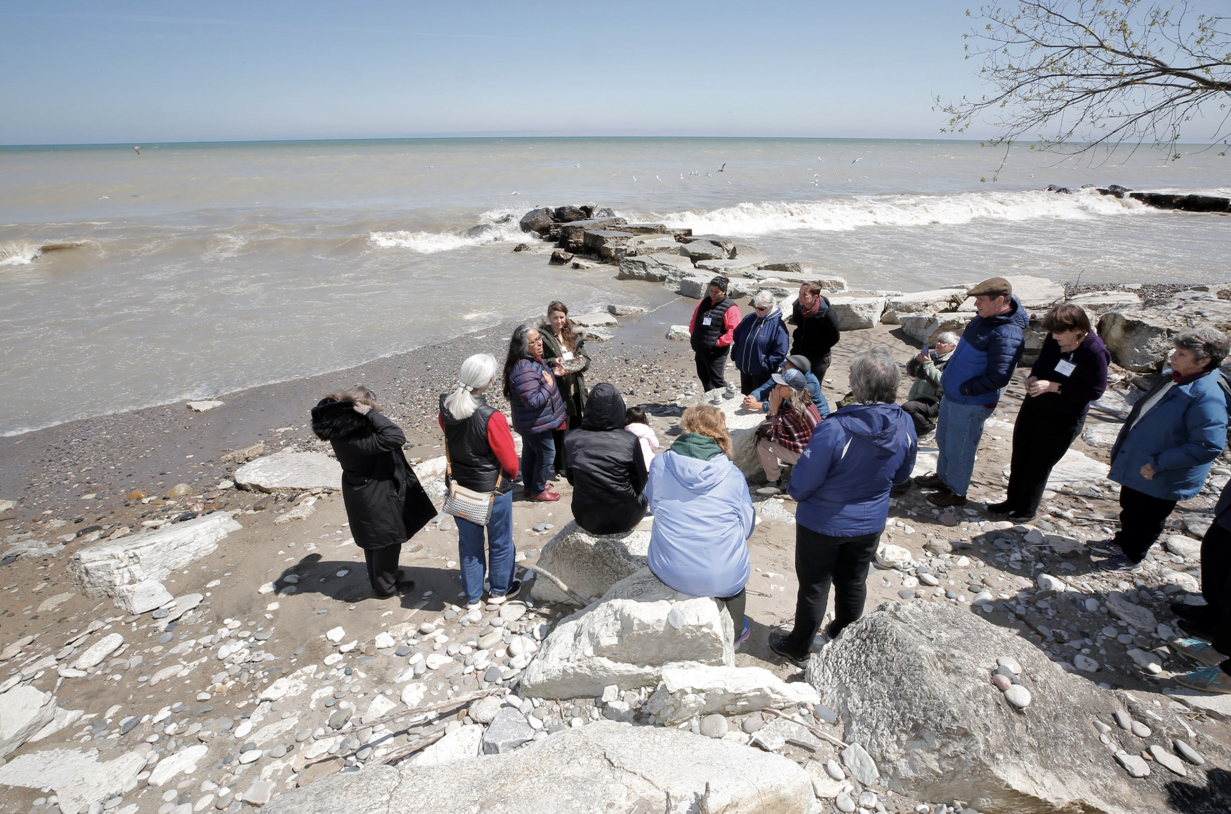 Focus Communities gather by Lake Michigan with elder/advisor Pat McCabe