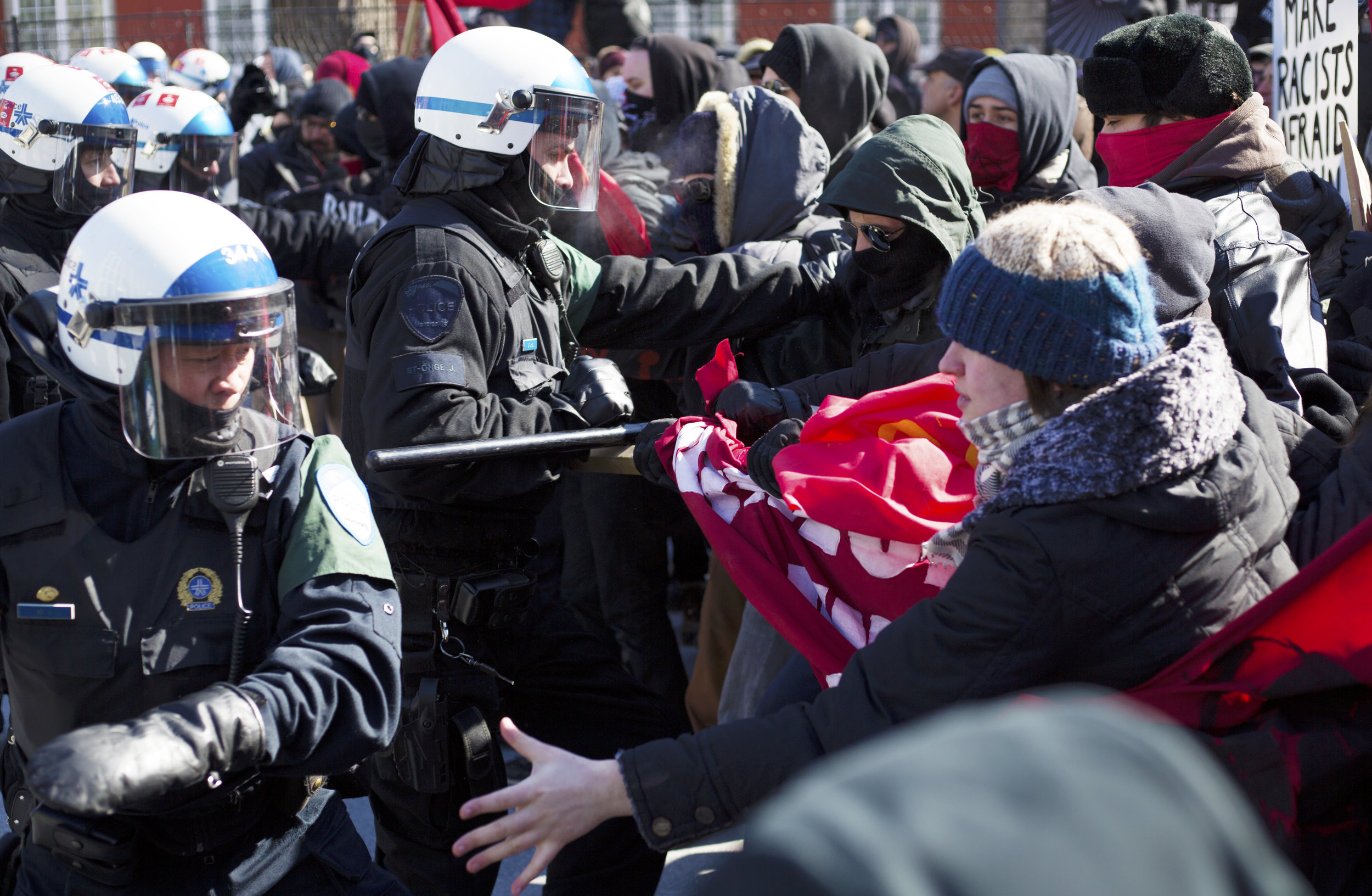  Montreal riot police swings a baton at a protestor at a demonstration against fascism (March 4 2017) 