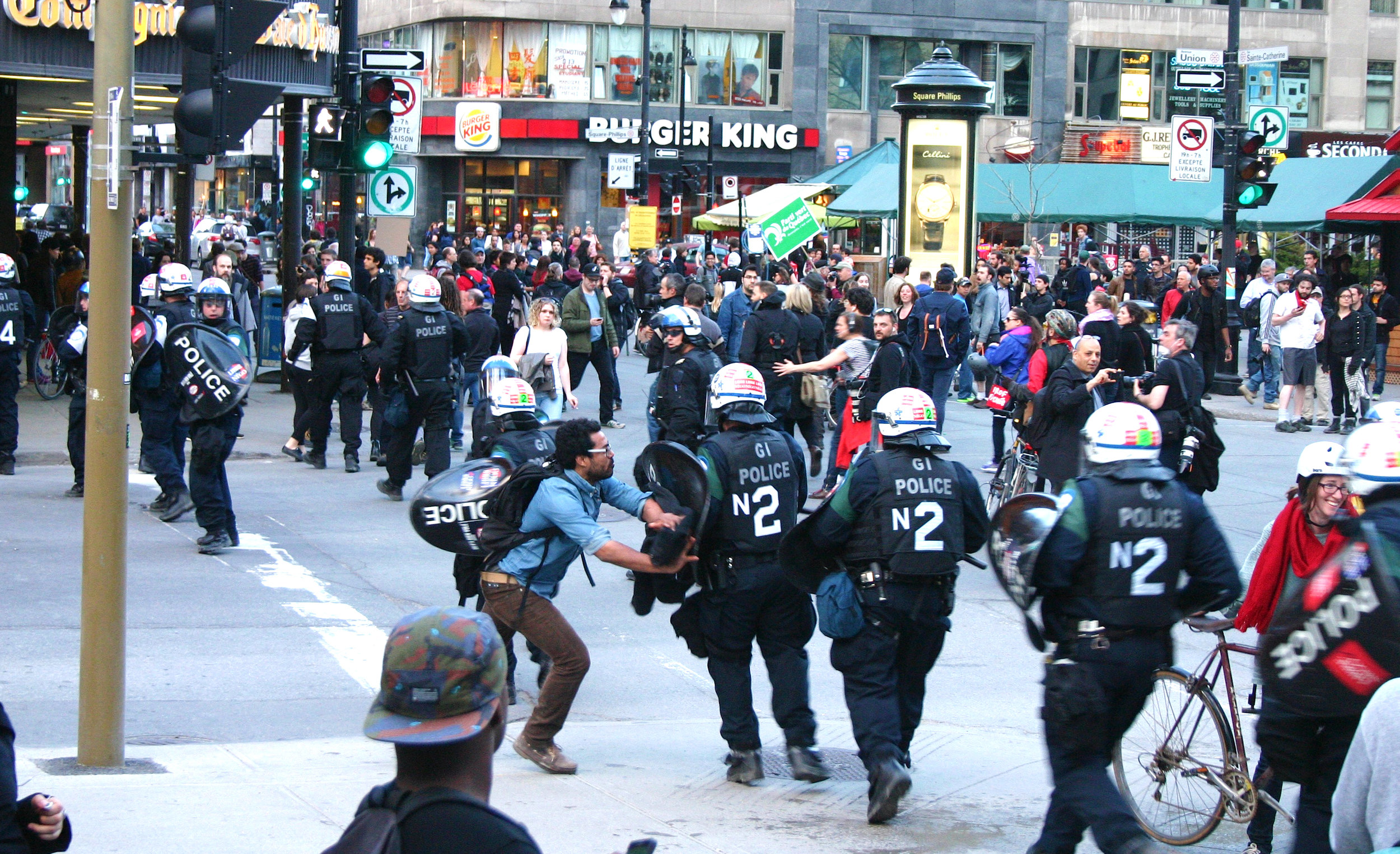  A protester challenges a charging riot police line at a May Day demonstration in Montreal (May 1 2015) 