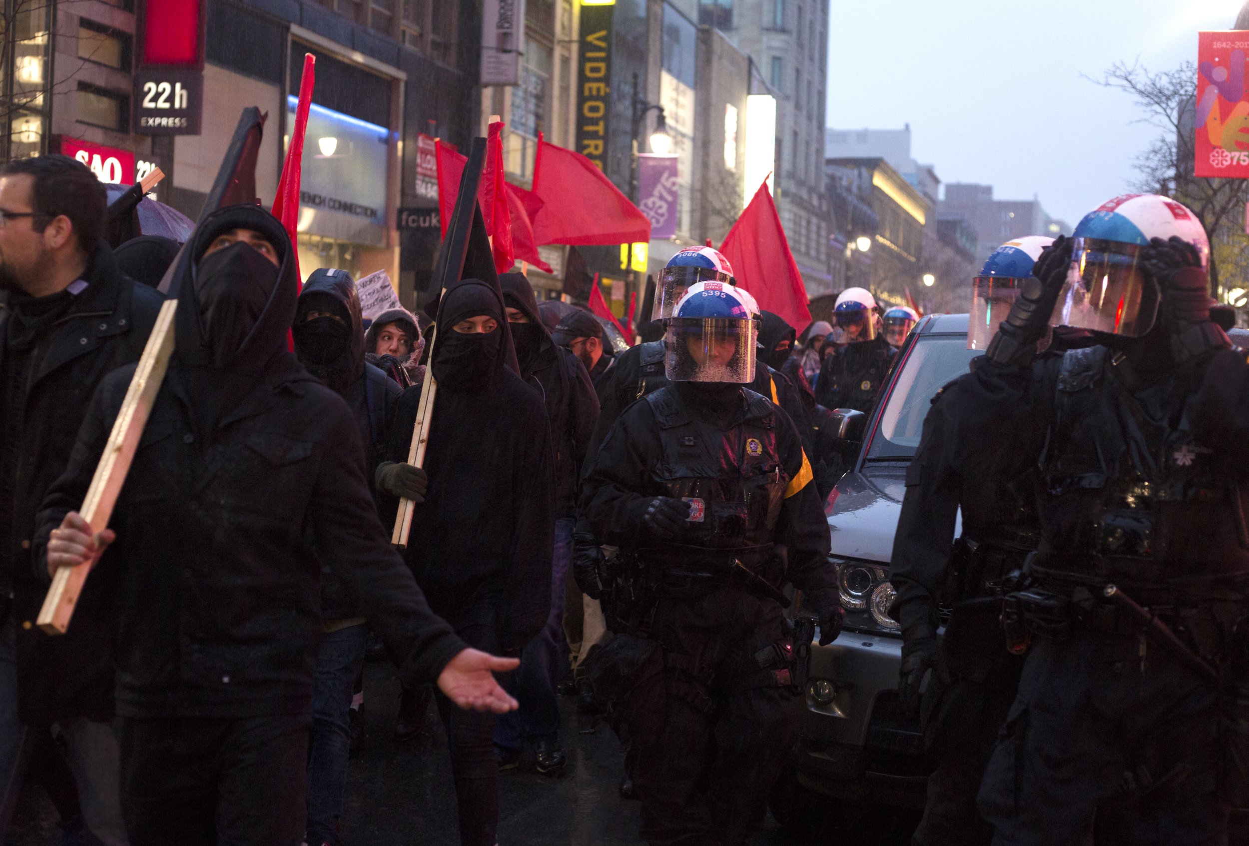  Protestors and SPVM walking in the rain during a May Day demonstration. May 1 2017 