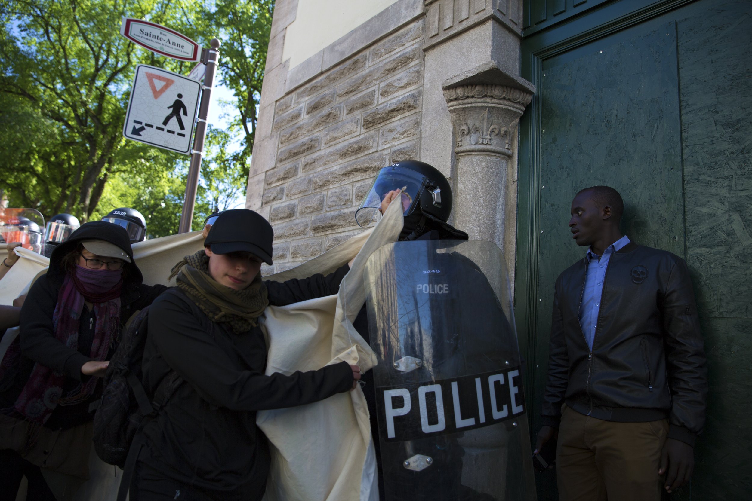  Protester at the G7 summit demonstrations in Quebec City pushes a Quebec City riot police. June 9 2018.  