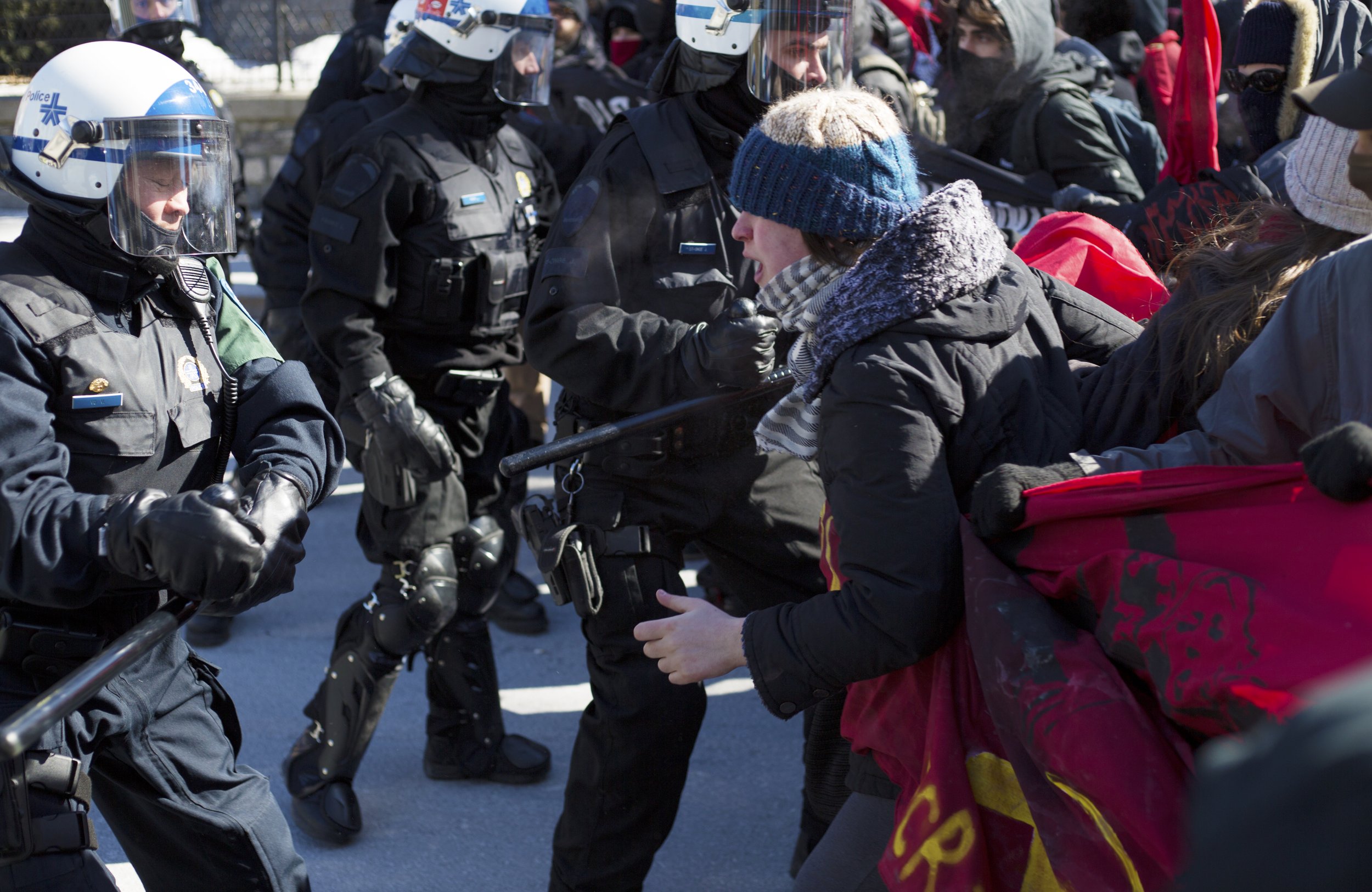  Montreal riot police swings a baton at a protestor at a demonstration against fascism. (March 4 2017) 