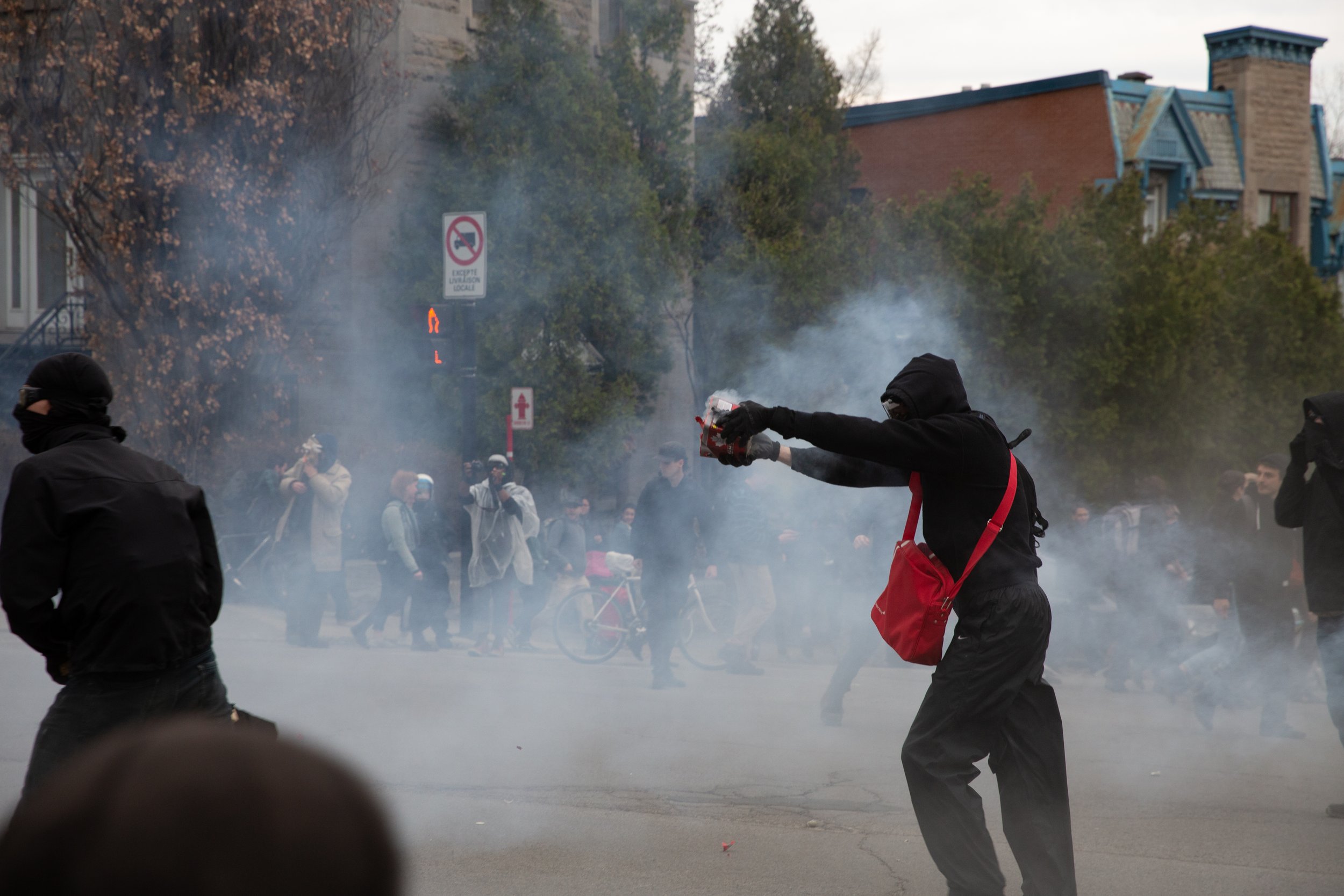 Protester shooting fireworks at Montreal Police (SPVM) during May Day demonstrations. May 1, 2018. 