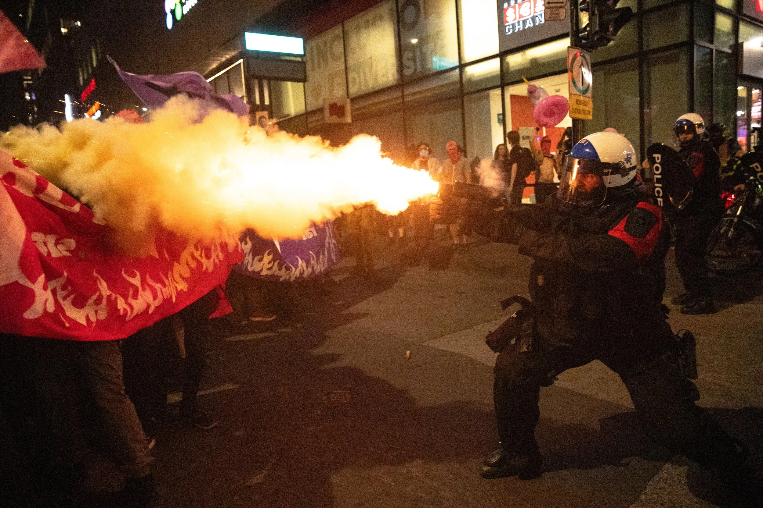SPVM riot police shoots a muzzle munition at demonstrators during Rad Pride. Montreal, Quebec. August 9, 2025.