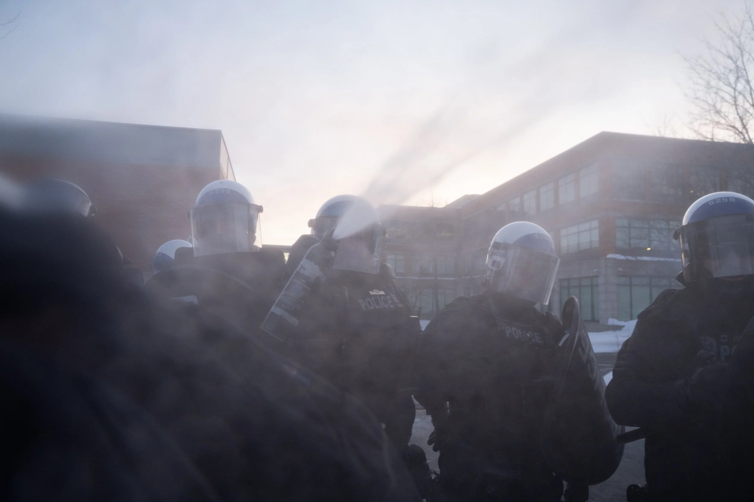  SPVM riot police pepper spraying me at a demonstration against GardaWorld and their business with US’ ICE. St-Laurent, Montreal, Quebec. February 13, 2026.  