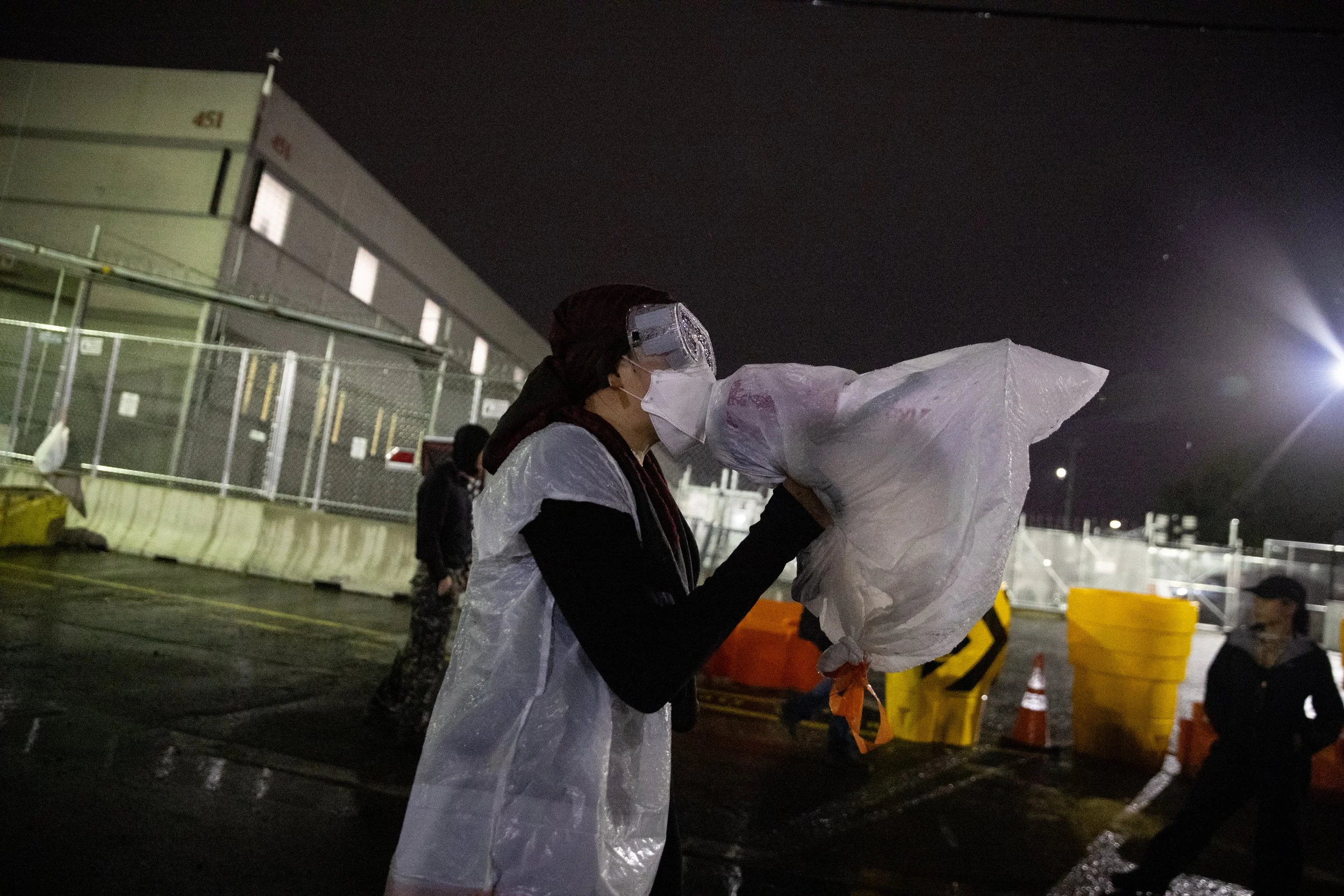  Protester chants into a loudspeaker in the rain at a demonstration outside ICE’s Delaney Hall Detention Center. Newark, New Jersey. June 6, 2026. William Wilson.  