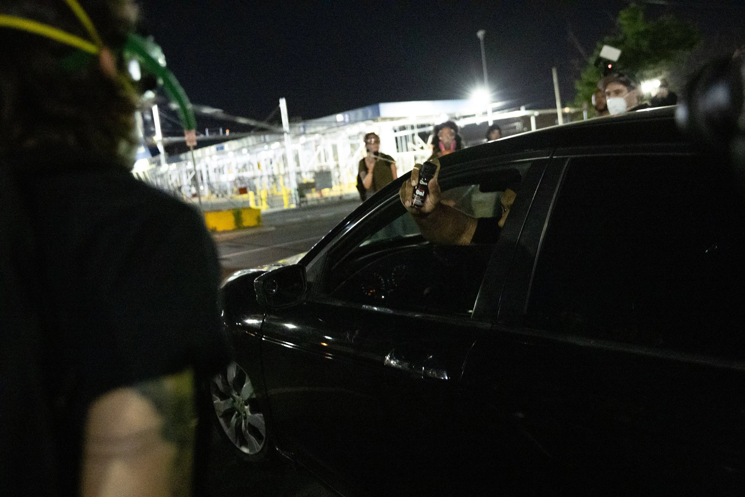  GEO Group employee pepper sprays protesters through his vehicle’s driver side as he departs ICE’s Delaney Hall Detention Center. Newark, New Jersey. June 5, 2026. William Wilson.  
