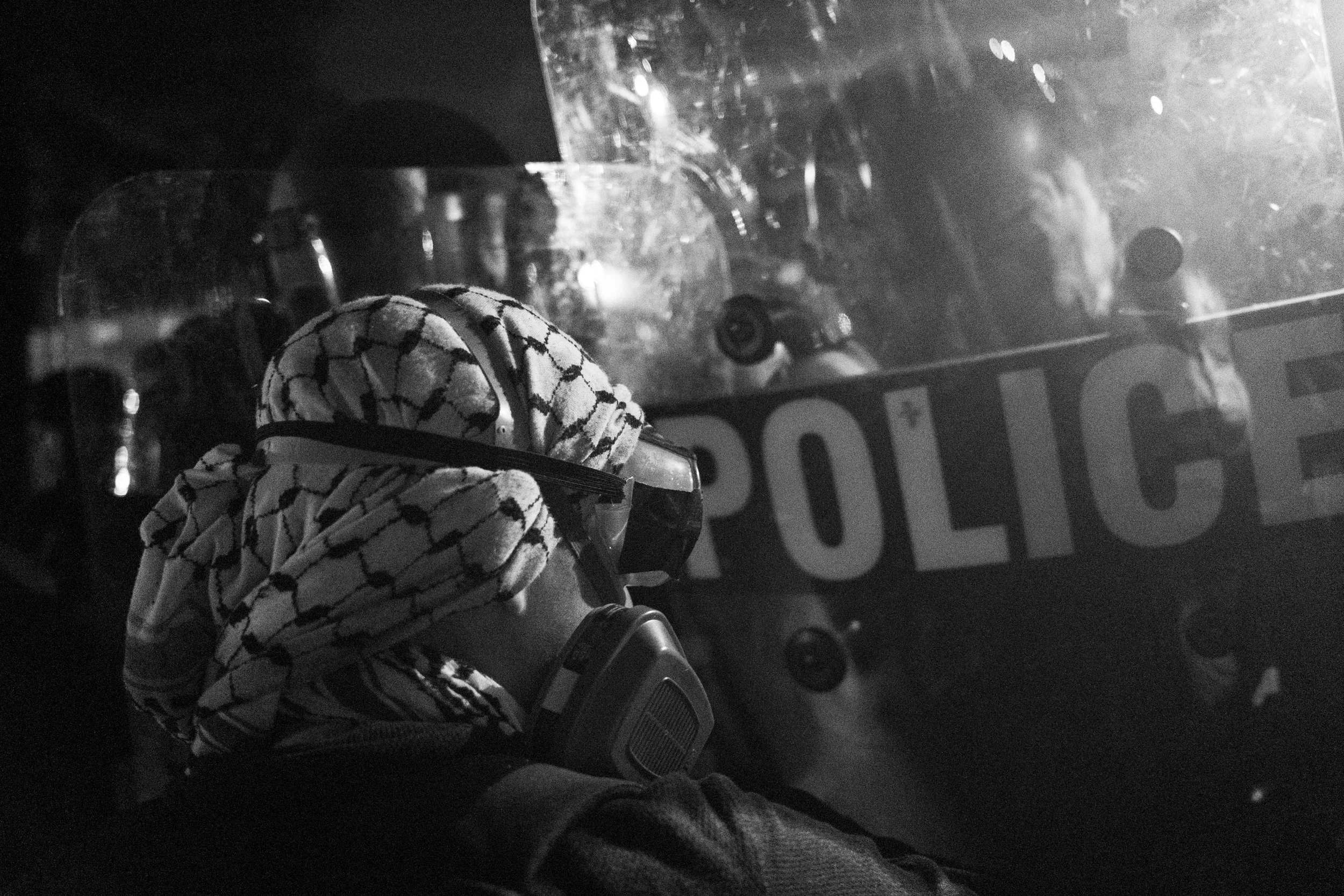  A demonstrator confronts Newark PD riot police at a protest outside ICE’s Delaney Hall Detention Center. Newark, New Jersey. June 6, 2026. William Wilson.  