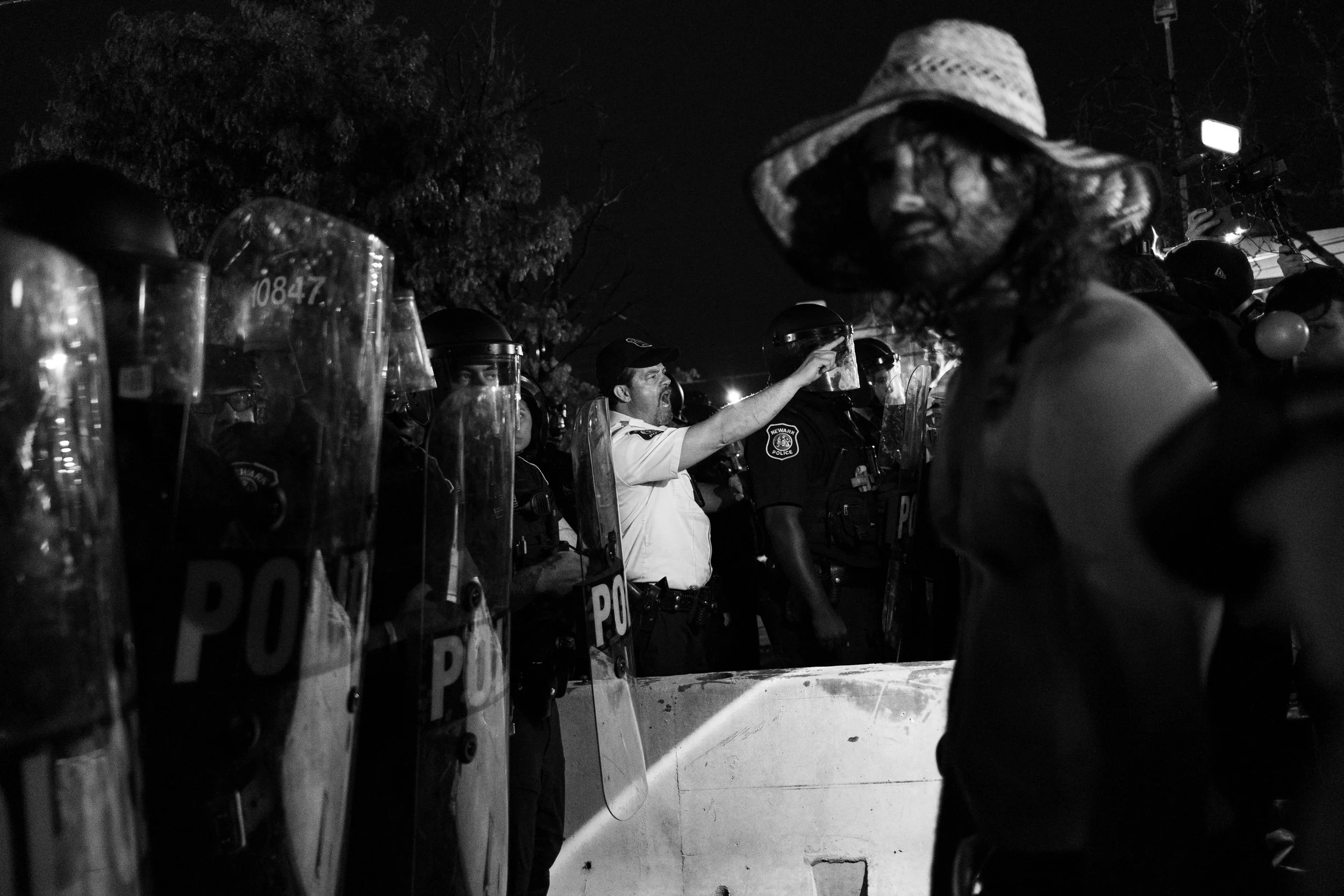  A protester confronts Newark PD riot police at a protest outside ICE’s Delaney Hall Detention Center. Newark, New Jersey. June 6, 2026. William Wilson.  