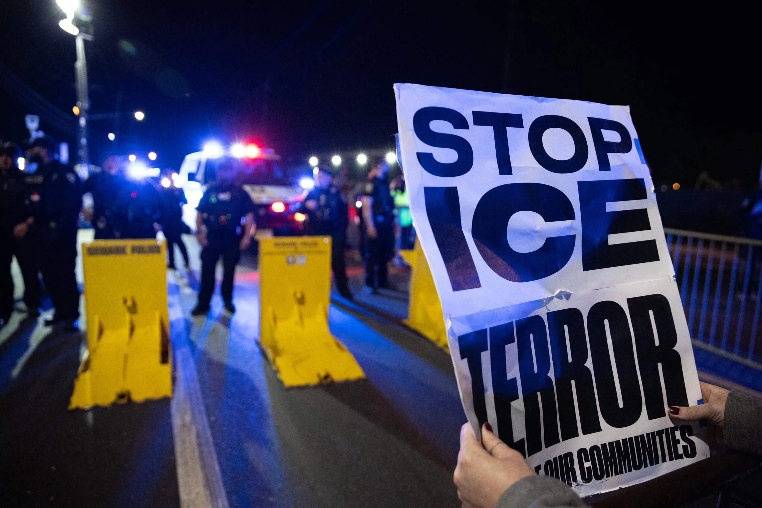  Protester holds a sign after dispersion of the demonstration by Newark PD outside ICE’s Delaney Hall Detention Center. Newark, New Jersey. June 3, 2026. William Wilson.  