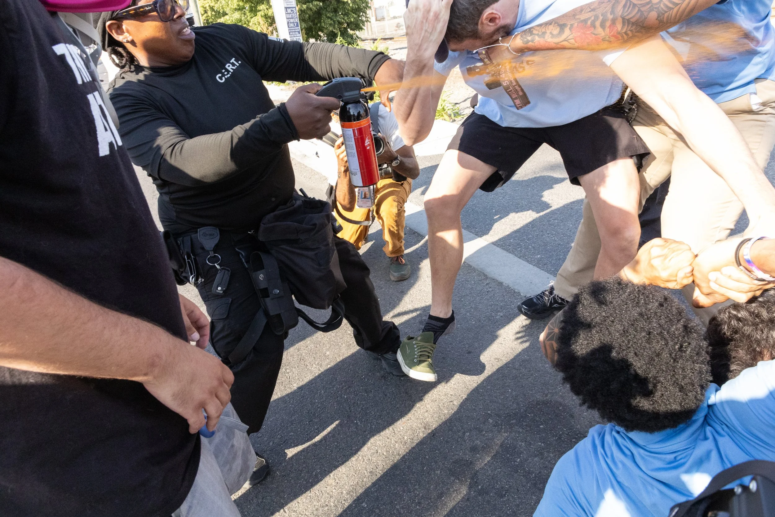  GEO Group employee pepper sprays a demonstrator during a protest outside ICE’s Delaney Hall Detention Center. Newark, New Jersey. June 5, 2026. William Wilson. 