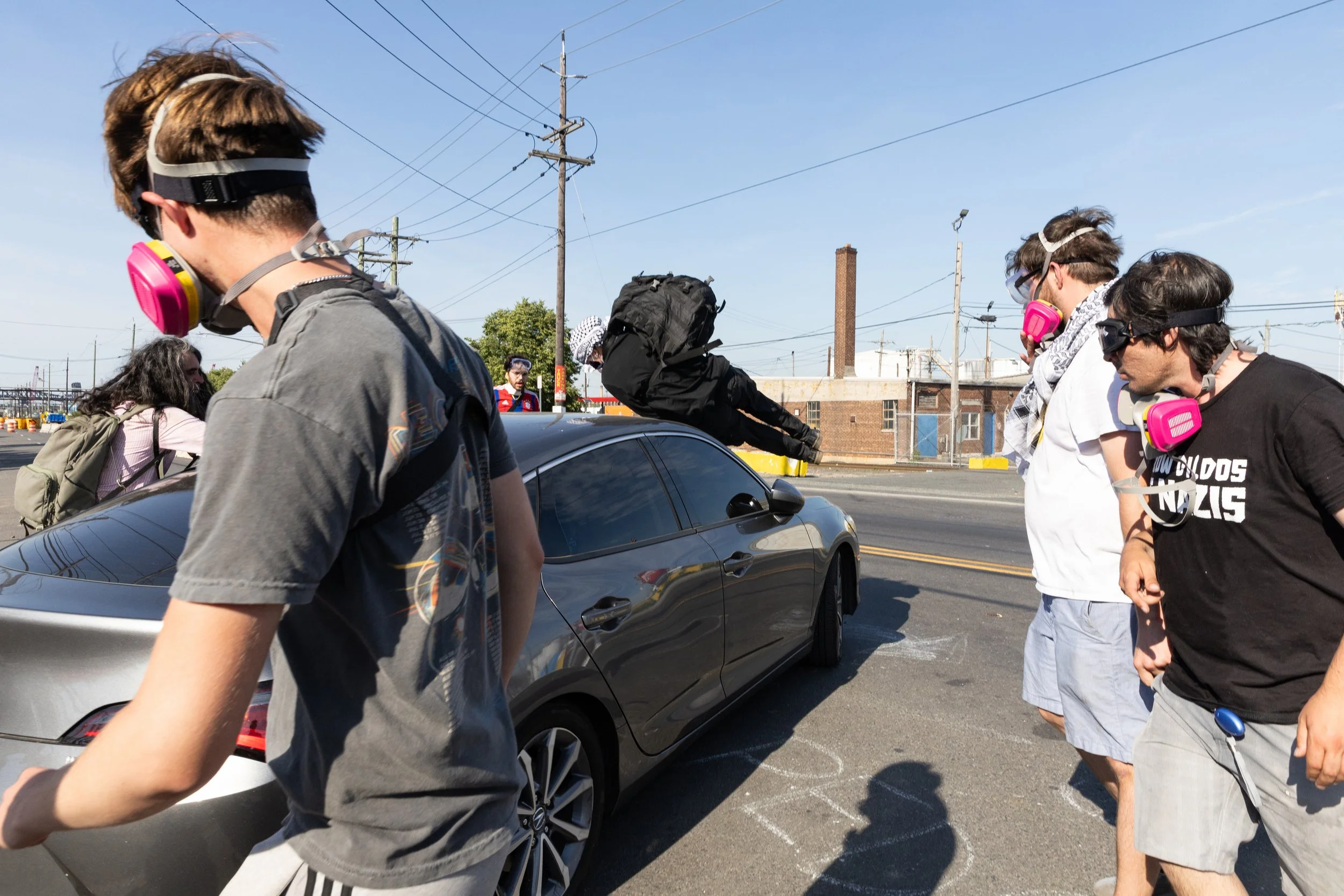  A demonstrator is deliberately struck by a GEO Group employee’s accelerating vehicle during a picket outside Delaney Hall Detention Center. Newark, New Jersey. June 5, 2026. William Wilson. 