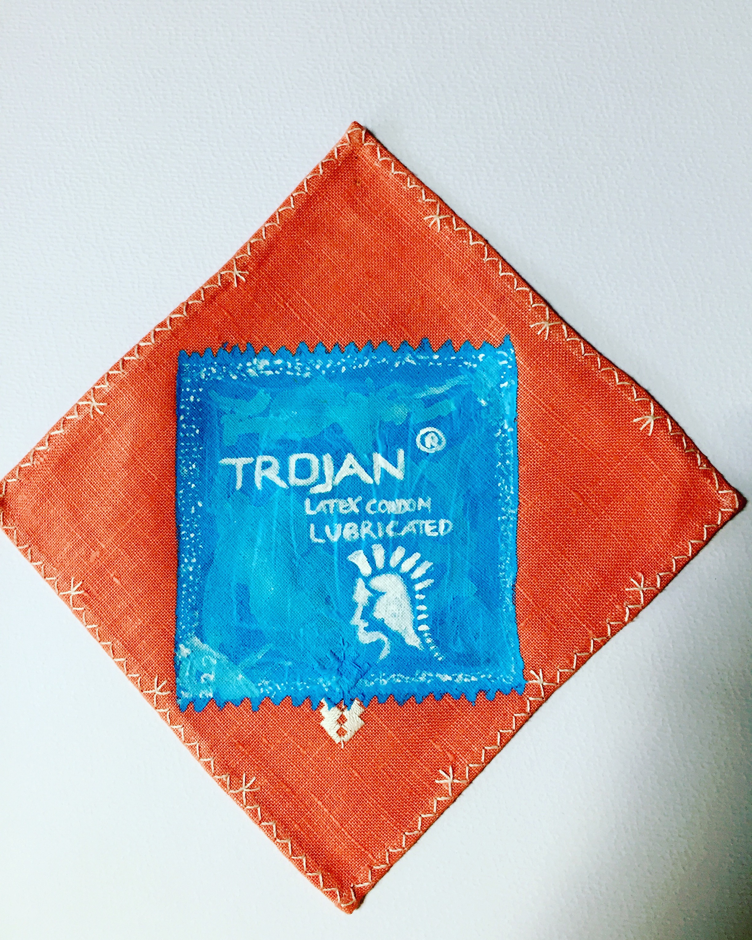 OVER THE COUNTER SERIES: TROJAN CONDOMS-acrylic on a vintage embroidered linen napkin-3”X3”-2017 $150
