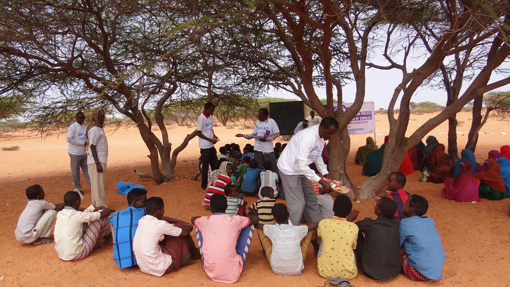   Somalis who have benefited from free tuition at the Iftiin school in Adado teach nomads in the literacy campaign  