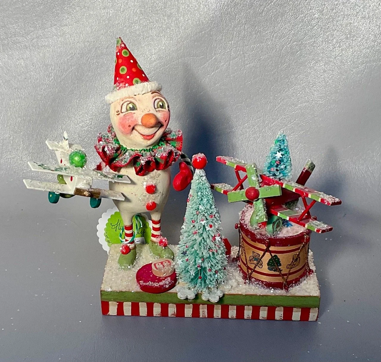 Flying Frosty~Snowman with drum with wood plane on drum and in hand 6” x 2.5” wood base.   $165.00