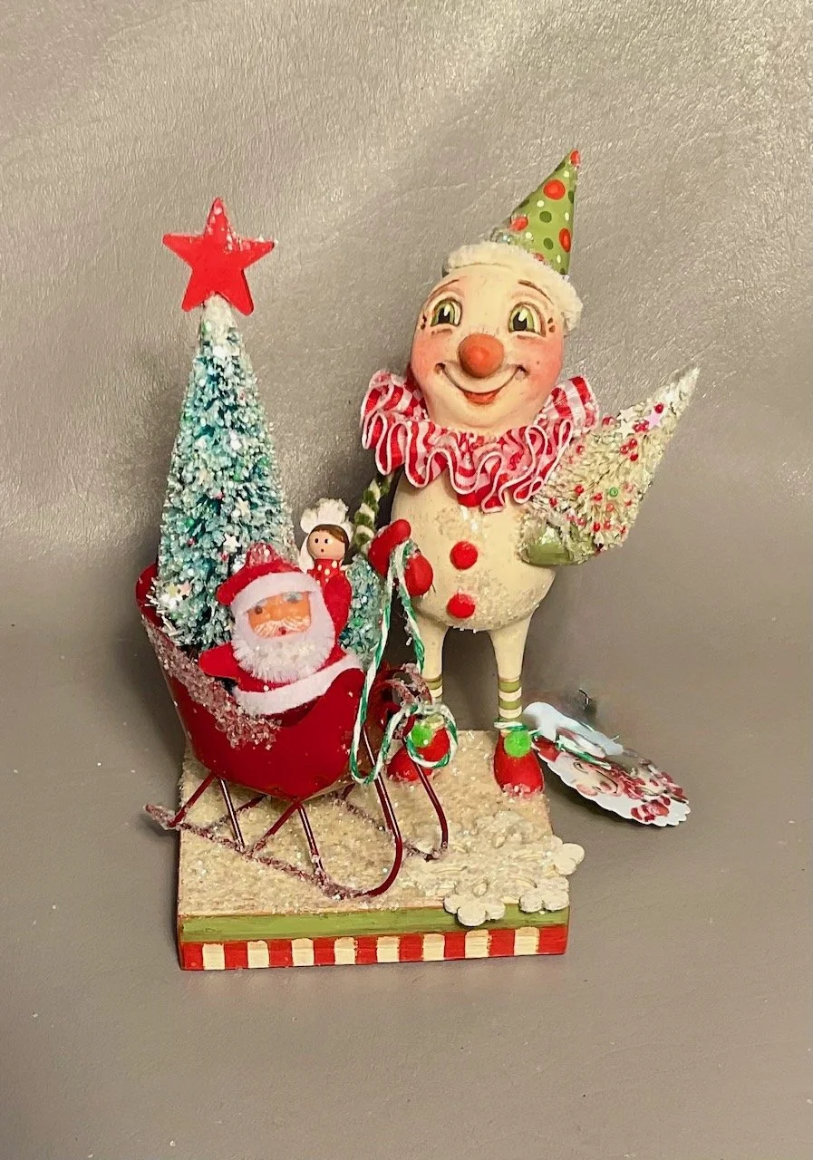 Snowflake’s Joy~ Snowman with red tin sleigh, vintage Santa, tree vintage treasures on 4” square base.  $165.00