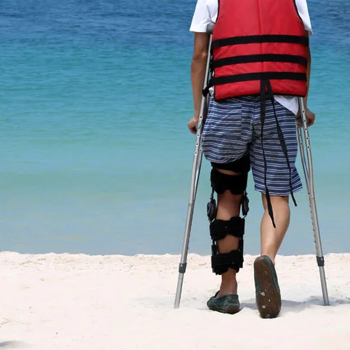 97993924-disabled-man-with-crutches-while-travel-on-the-beach-ocean-views-background-small-500x500.jpg
