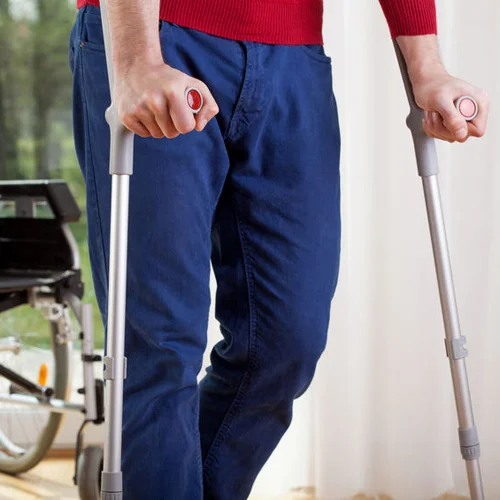 28646617_s-horizontal-view-of-a-disabled-man-on-crutches_500x500.jpg