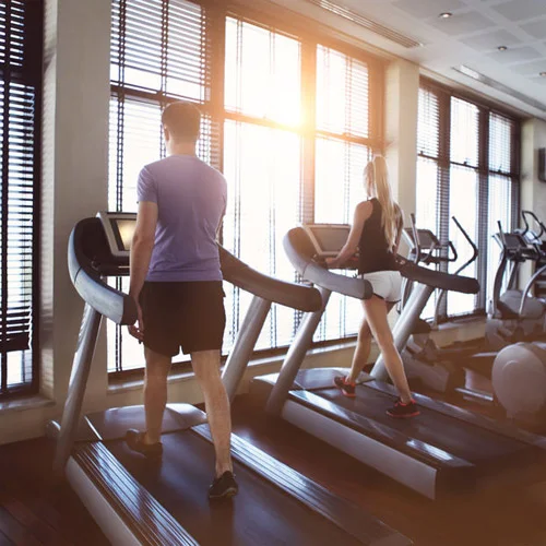 40375927-healthy-man-and-woman-running-on-a-treadmill-in-a-gym_500x500.jpg