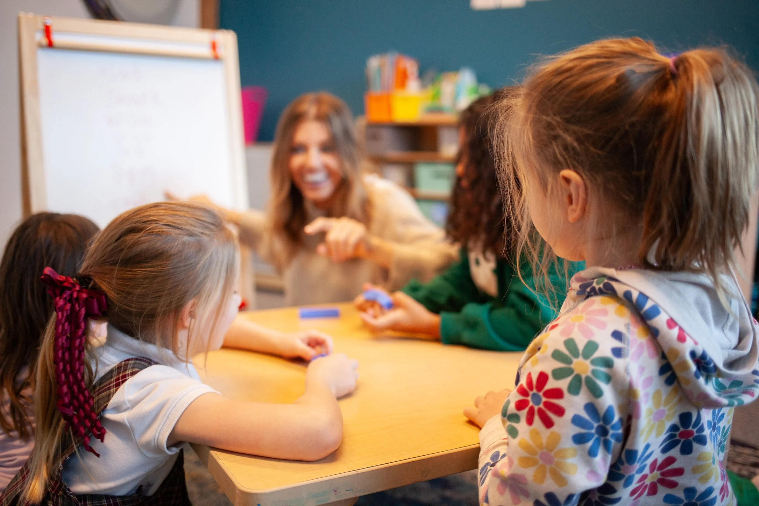 Miss Beth teaching long vowel words with "u" to first graders to support reading literacy
