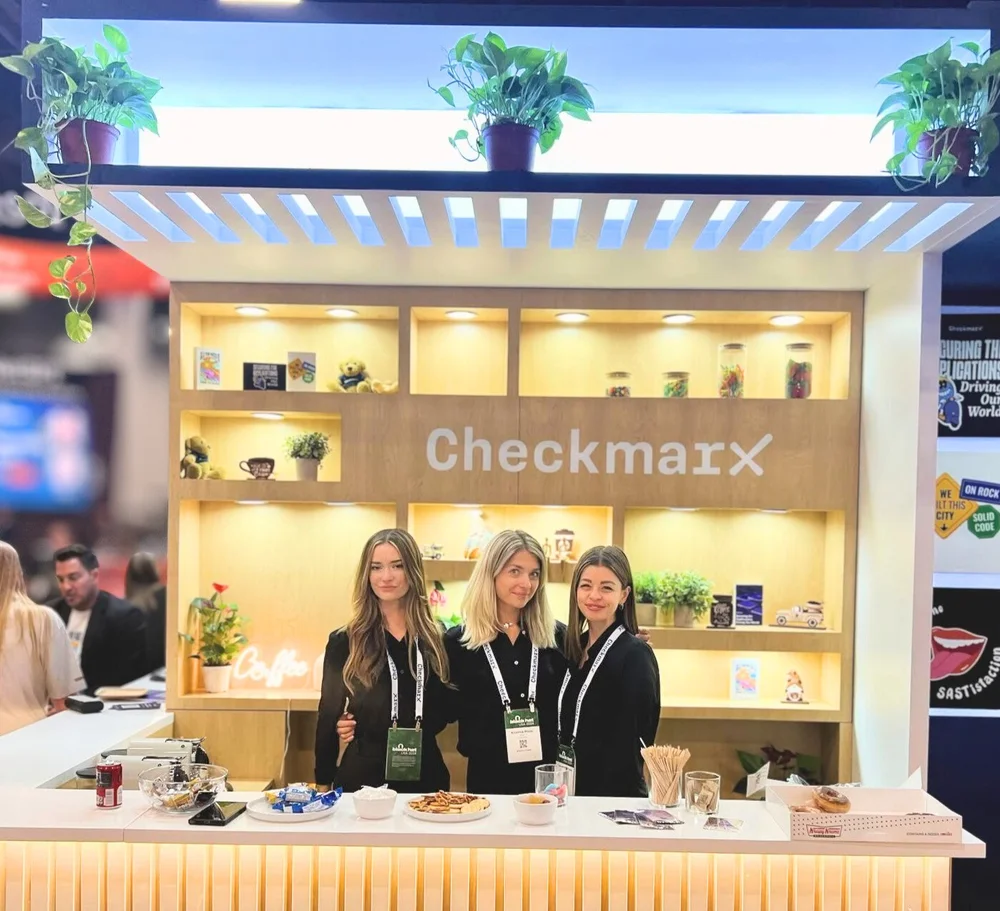 Convention hostesses supporting a trade show booth