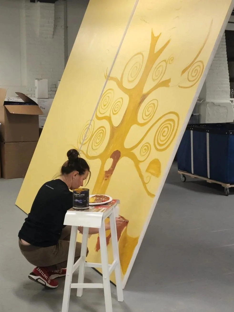 Anna Yakimenko painting a custom scenic panel for the Immersive Van Gogh exhibition in Boston.