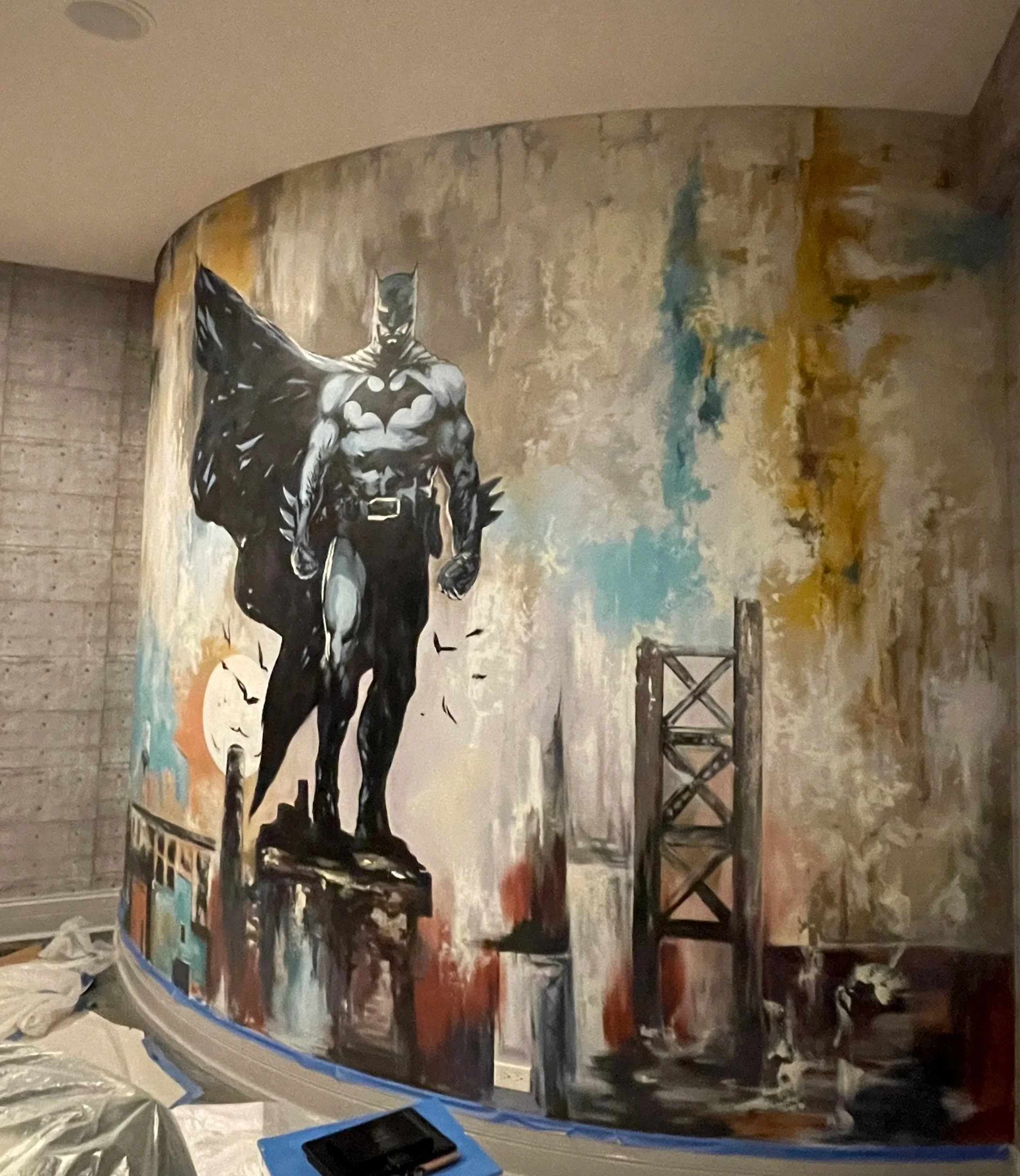 Batman-inspired wall mural in a residential home gym