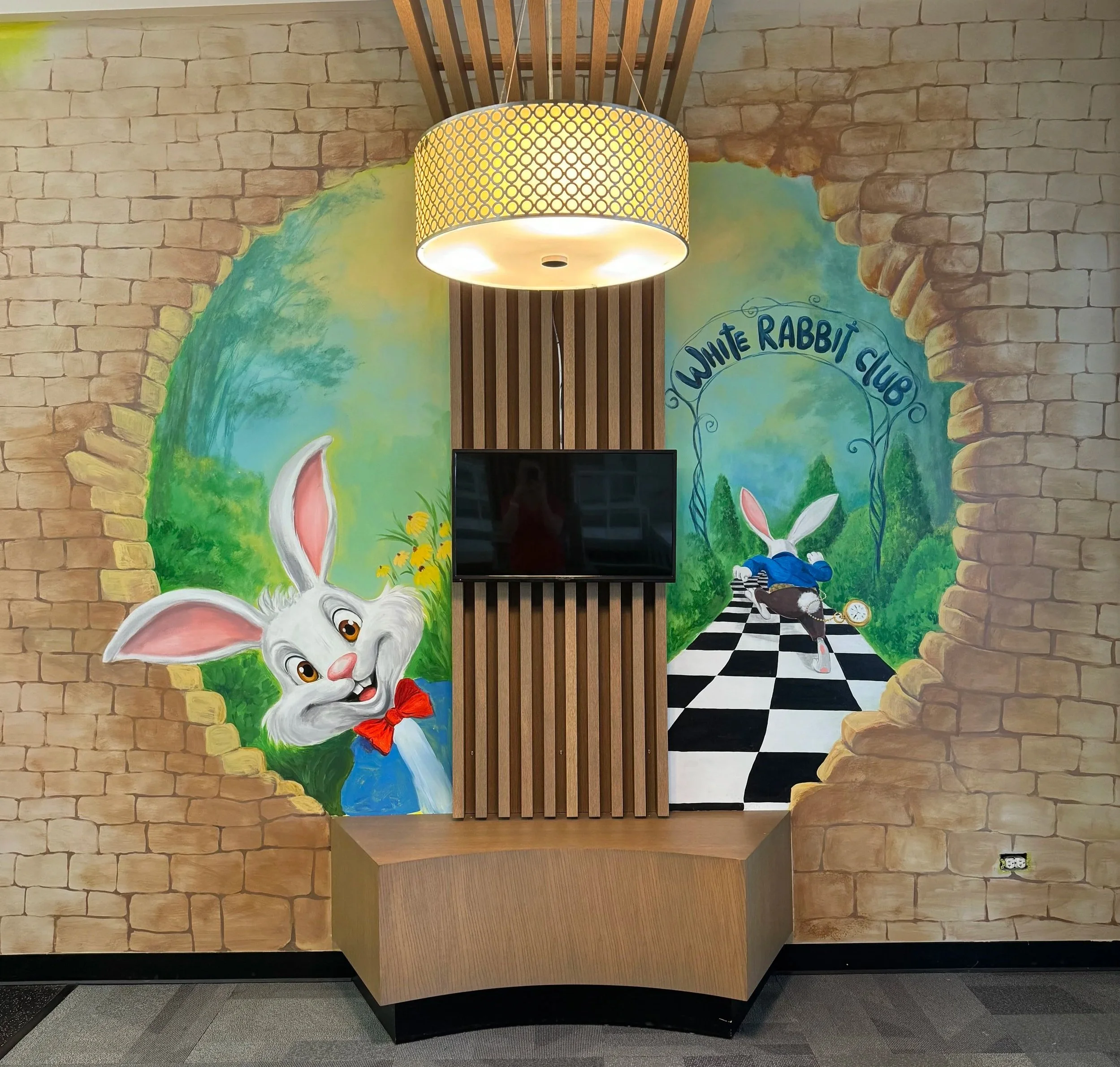 Alice in Wonderland themed kids club mural featuring the White Rabbit at White Rabbit Kids Club in Palatine, Illinois, by Anna Yakimenko.