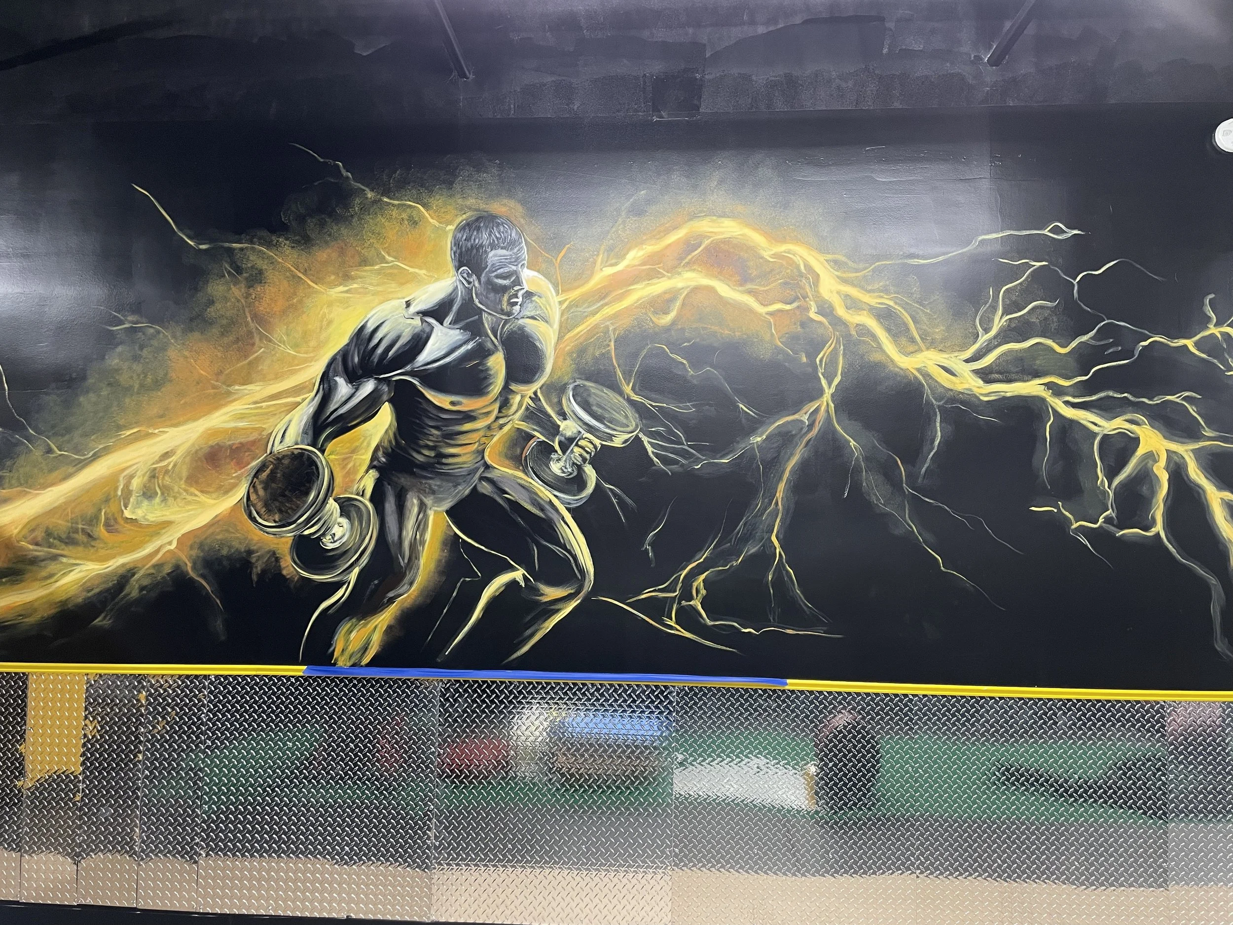 Custom hand-painted performance gym mural featuring an athlete surrounded by electric energy.