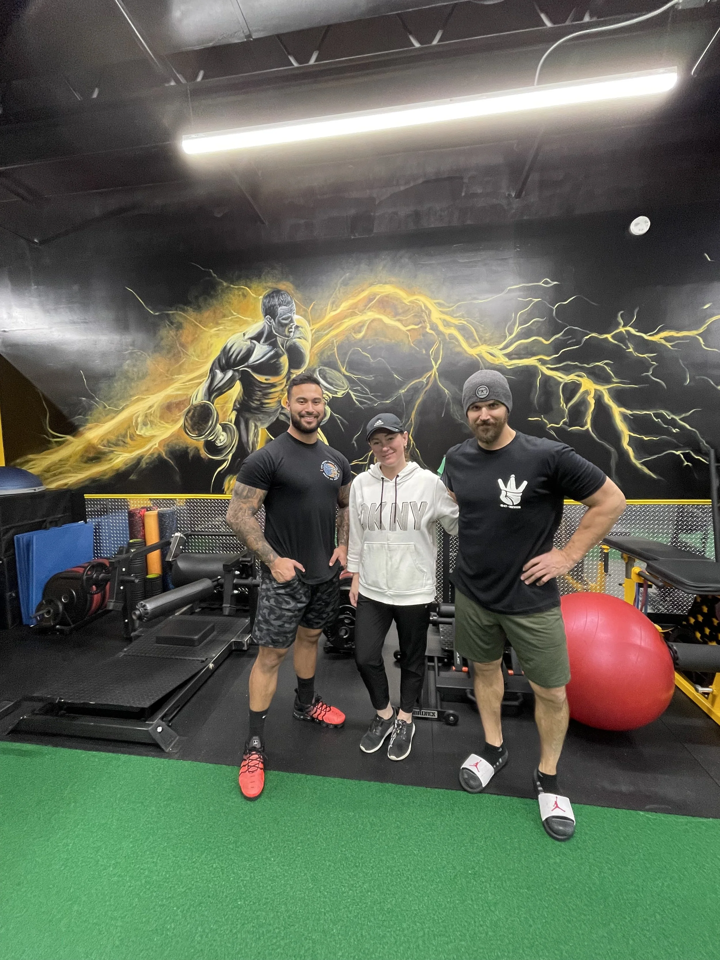 Completed performance gym mural with the athletes and training space.