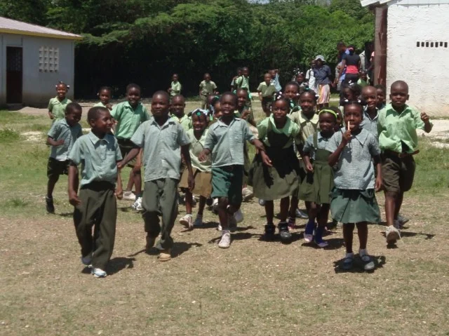 School children in our newest site run to greet GOALS and Waves 4 Water