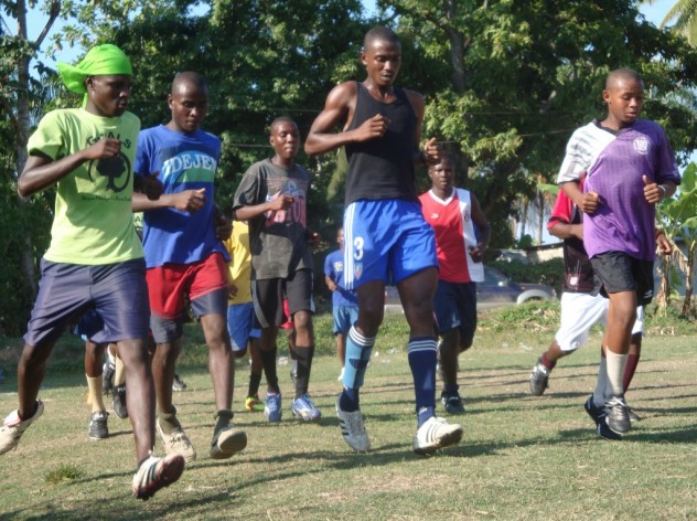 Wilio, at left, warms up with the team