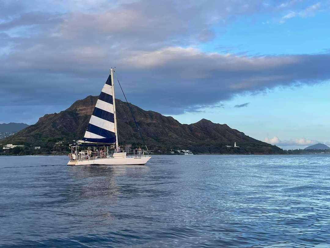  Sailing trimaran with large party off of diamond head enjoying a sunset cruise. 