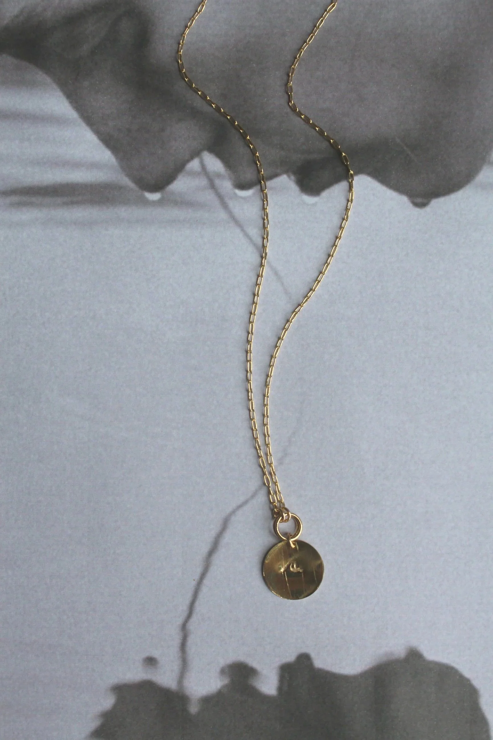 14ct gold filled hand stamped wave disc talisman.