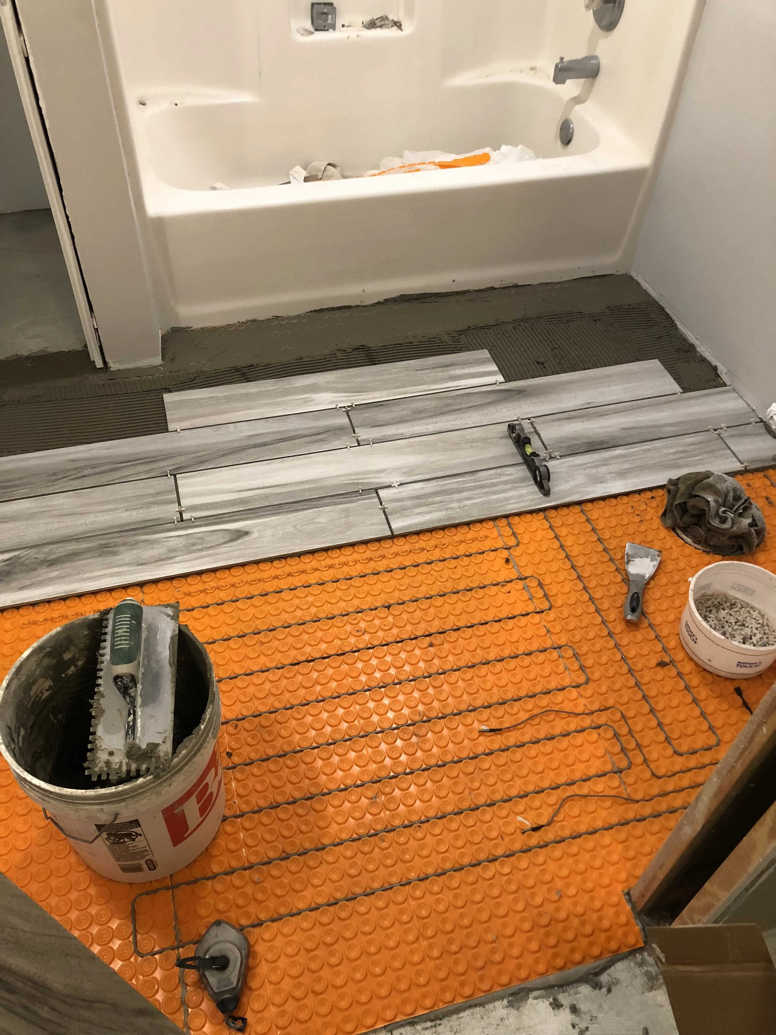 Installation of energy-efficient radiant in-floor heating system during a custom home build by Schmidt Construction in Chetek, Wisconsin.
