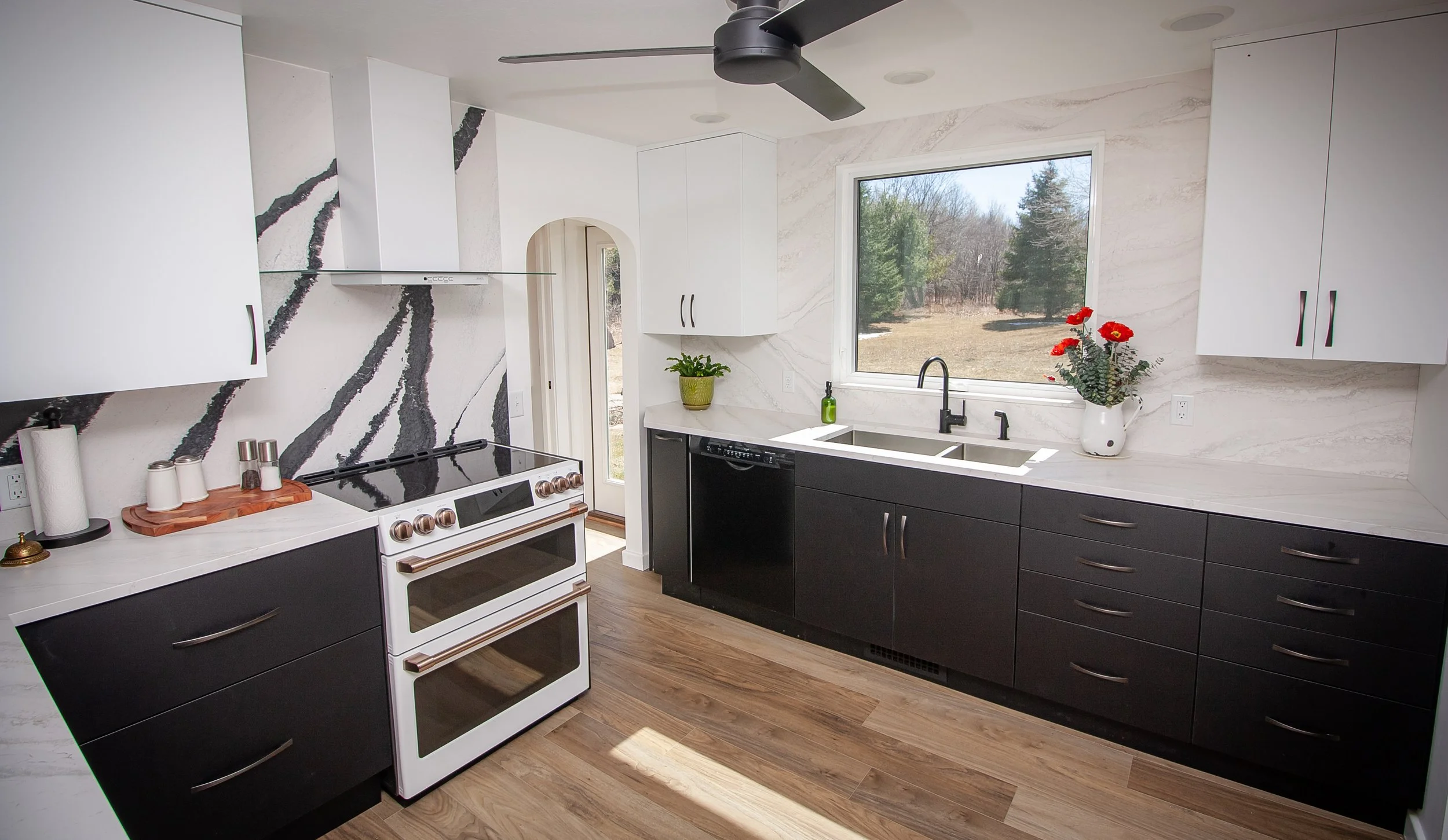 Spacious open-concept living room with large windows and custom lighting, showing modern interior design in Northwestern Wisconsin.