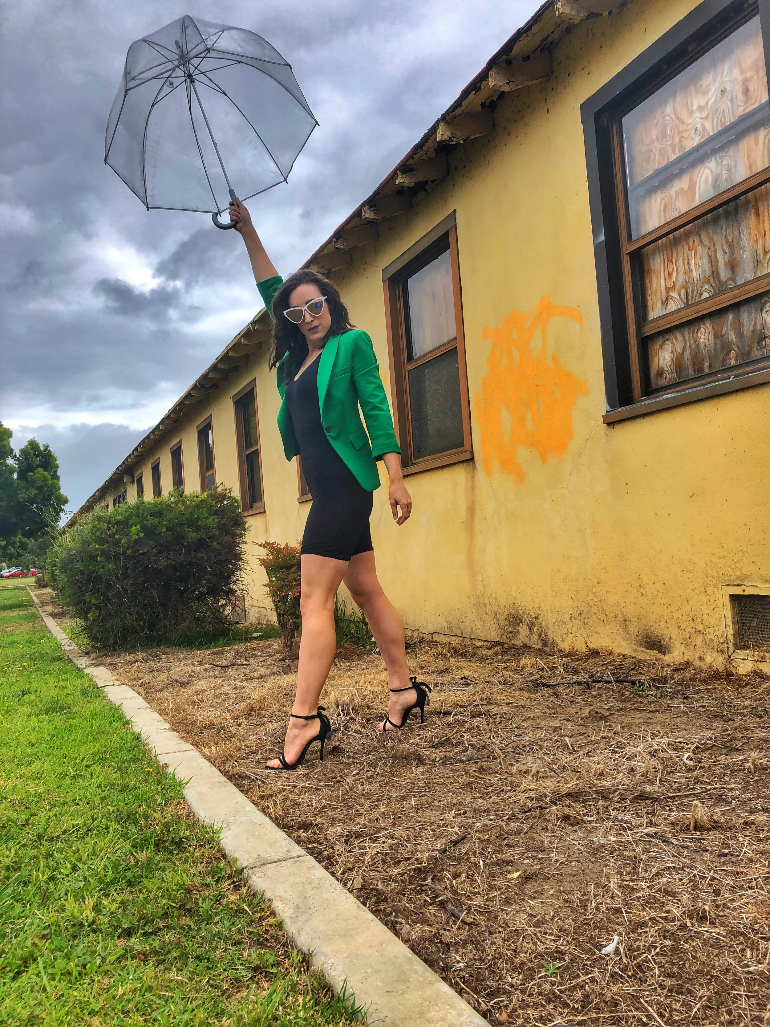 Totes Clear Umbrella. Green Blazer. Bike Shorts. Schutz heels.