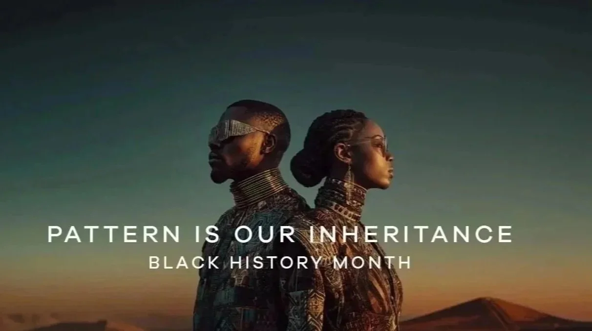 Two Black individuals stand back-to-back in profile against a warm desert sunset, dressed in richly patterned, culturally inspired garments with sculptural metallic neckpieces. Text overlay reads, “Pattern Is Our Inheritance – Black History Month.”