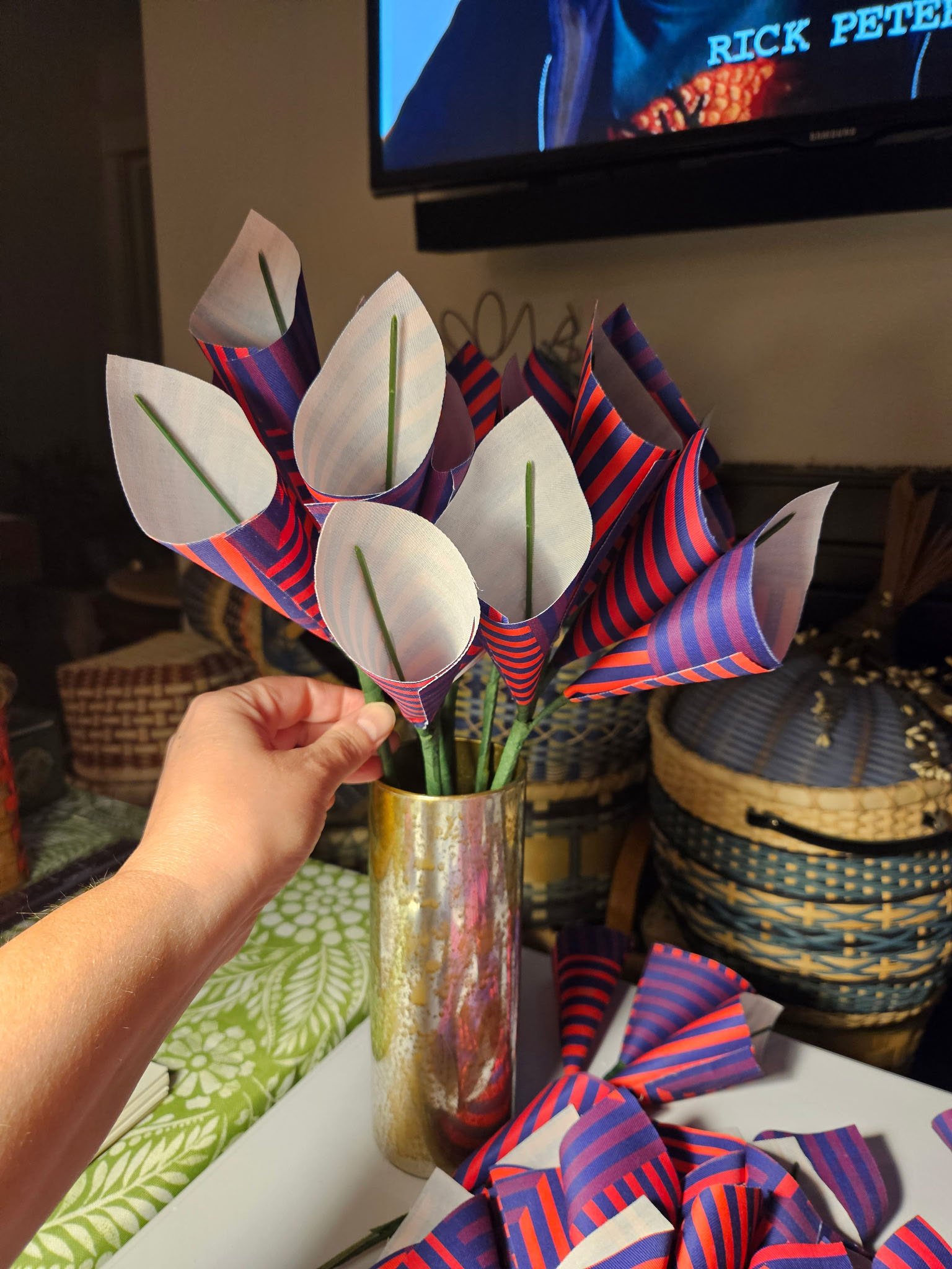 Handmade red, purple and navy fabric calla lily flowers arranged in a metallic vase.