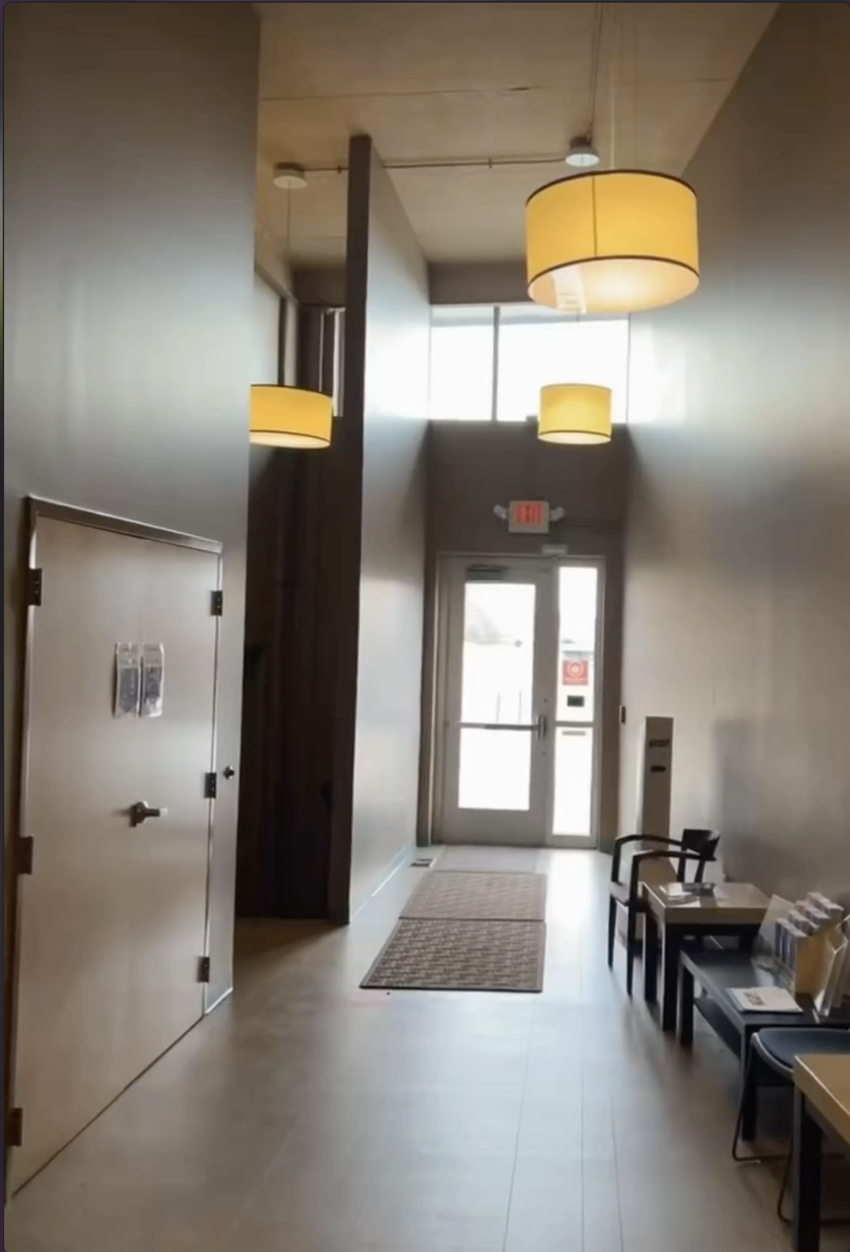 Before: neutral KC G.I.F.T. entryway with minimal design, high ceilings, and limited visual identity.