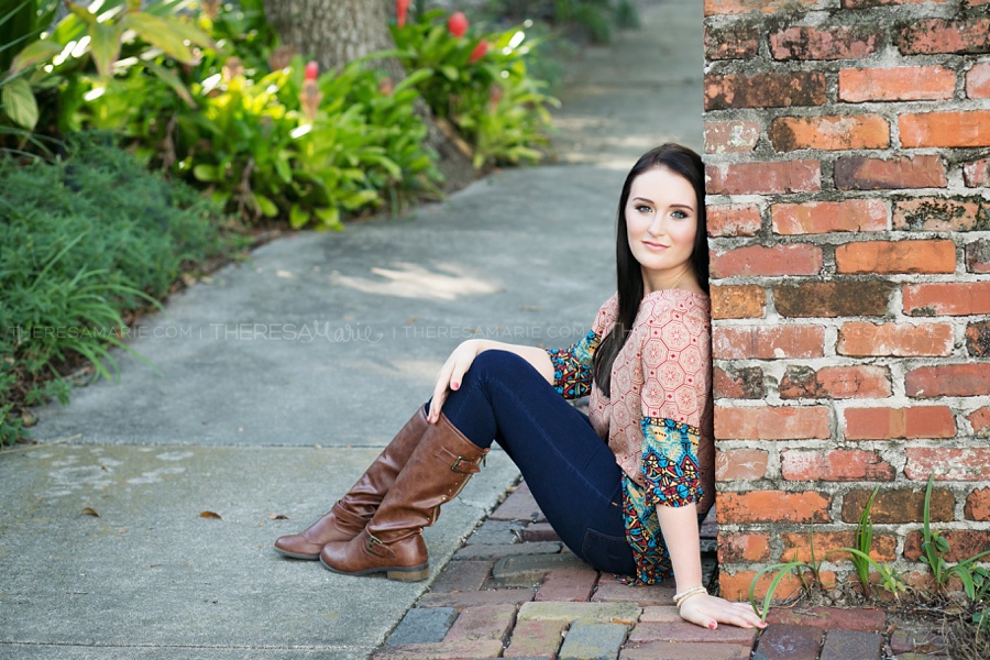 Urban senior photo in downtown Tampa with brick wall and pathway