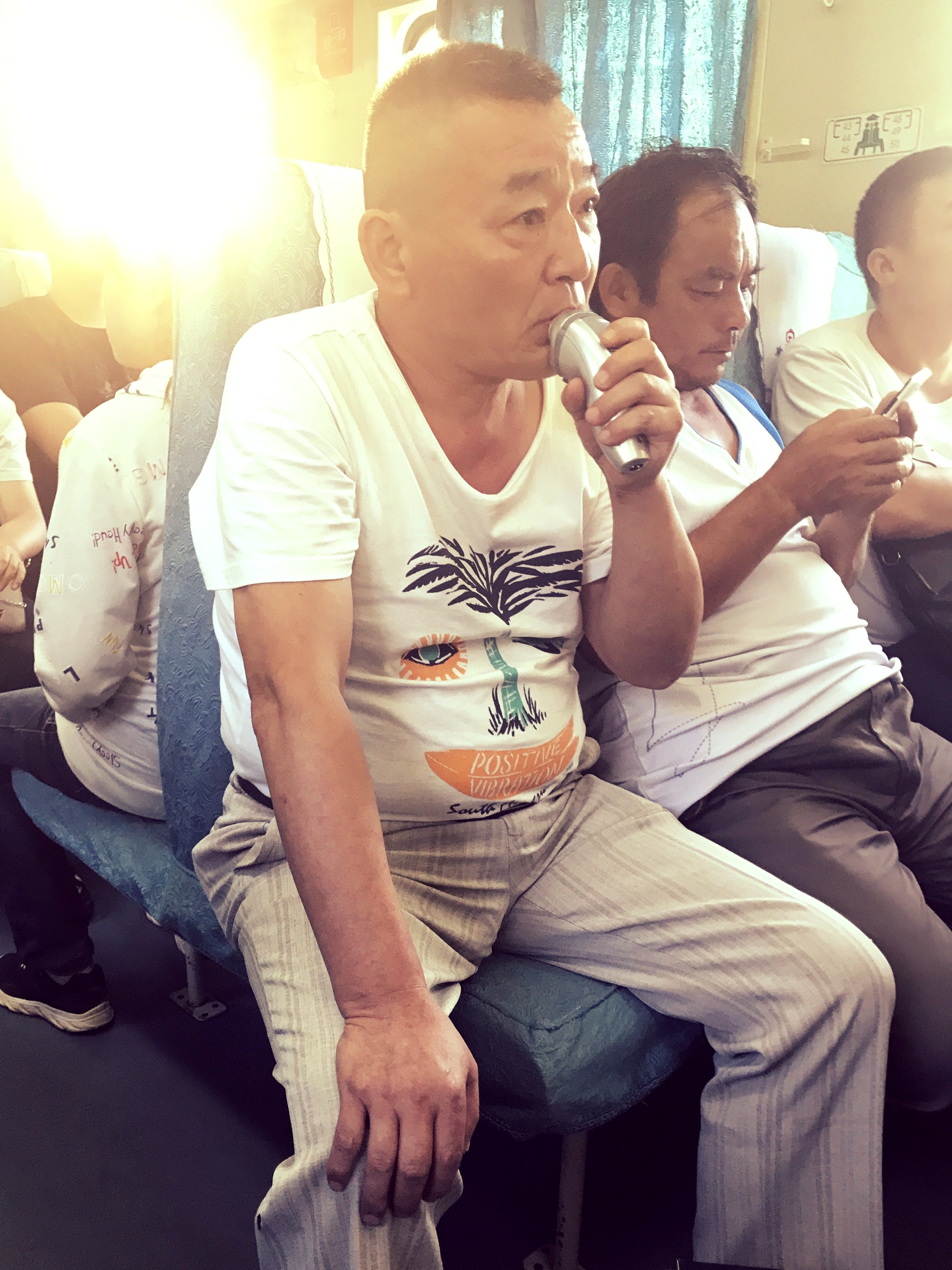 CHINESE MAN SHAVING ON THE TRAIN