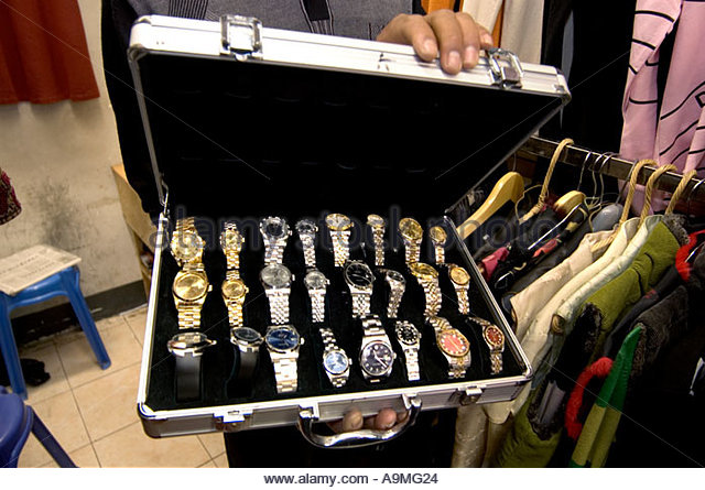 vendor-shows-case-of-fake-rolex-watches-for-sale-in-the-back-of-his-a9mg24.jpg