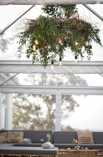 greenery chandelier with vintage bulbs