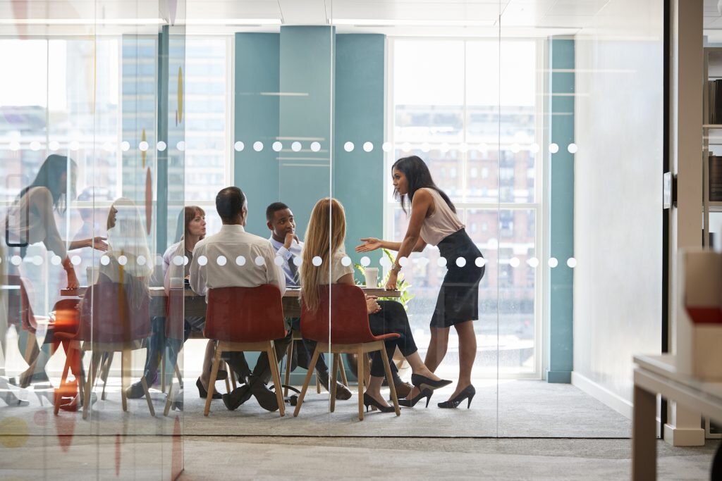 female-boss-stands-leaning-on-table-at-business-PD3WHMP-1024x683.jpg