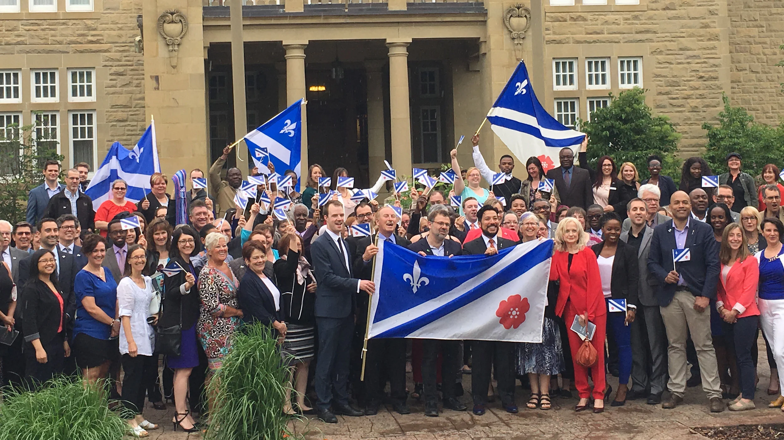 Photo Credit: Government of Alberta Photostream. Minister Ricardo Miranda and representatives from Alberta’s francophone community celebrate Alberta's first French Policy in front of Government House in Edmonton