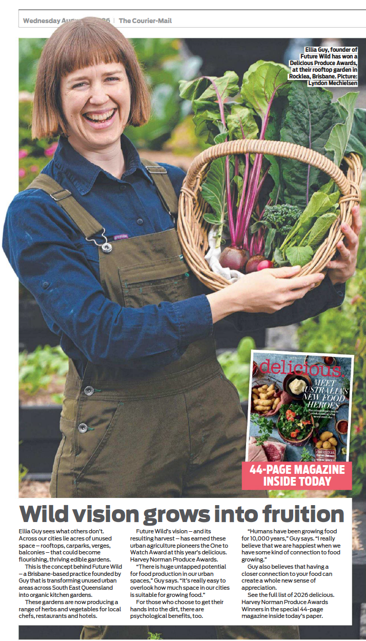 Ellia Guy, urban farmer, stands holding a basket of fresh produce grown in their urban agriculture projects
